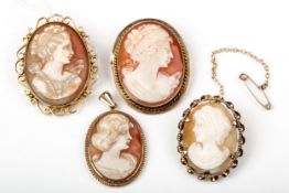 Three vintage gold and oval shell cameo brooches and a pendant.