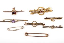 Eight early 20th century gold brooches, some gem set.