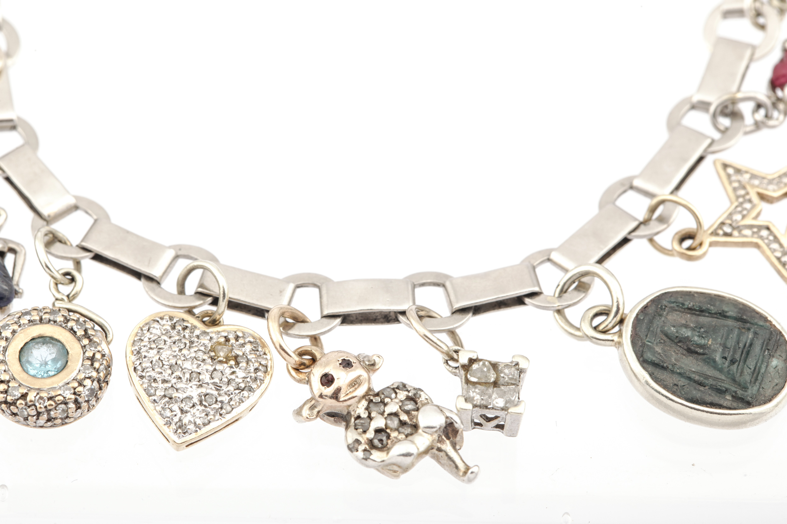 A 1940s French platinum bracelet in the manner of Boucheron hung with 21 various charms. - Image 3 of 6