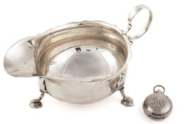 A silver sauce boat and a sovereign case.