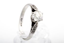 A mid-20th century platinum and diamond solitaire ring. The old-cut stone approx.