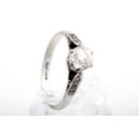 A mid-20th century platinum and diamond solitaire ring. The old-cut stone approx.
