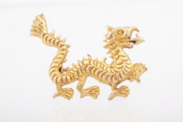 A high carat gold brooch in the form of a Chinese cloud dragon.