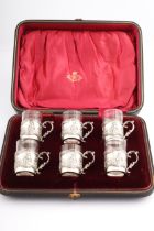 A set of six Edwardian silver and clear glass liquor glasses.
