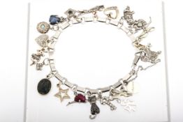 A 1940s French platinum bracelet in the manner of Boucheron hung with 21 various charms.