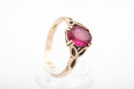 A 9ct gold and oval synthetic ruby single stone ring.