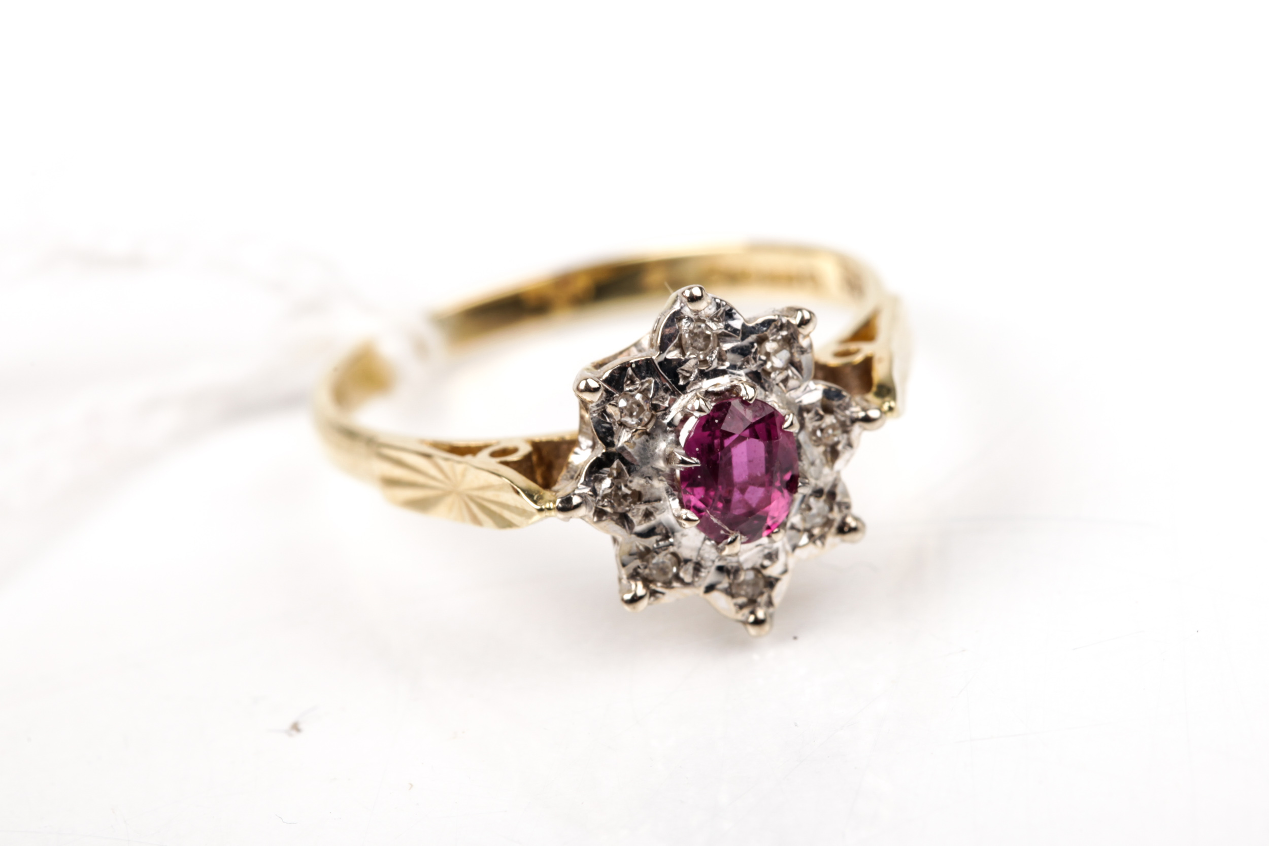 A vintage 18ct gold, ruby and diamond oval cluster ring.