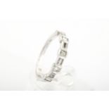 A modern 14ct white gold and diamond half-hoop ring.