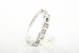 A modern 14ct white gold and diamond half-hoop ring.