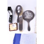 A silver mounted three piece dressing table set.