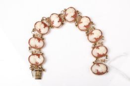 A vintage Italian gold and oval shell cameo panel bracelet.