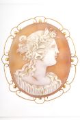An early 20th century gold and oval shell cameo brooch depicting Flora.
