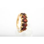 A vintage 9ct gold and garnet five stone ring.