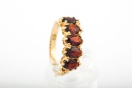A vintage 9ct gold and garnet five stone ring.