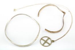 Two modern silver bangles and a pendant.