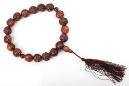 A string of 19th century(?) Chinese carved wood prayer beads.