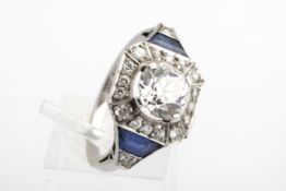 A mid-20th century platinum, diamond and sapphire cluster ring in the Art Deco manner.