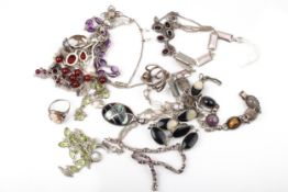 A collection of hard stone jewellery including an oval cabochon amethyst 12 stone bracelet.