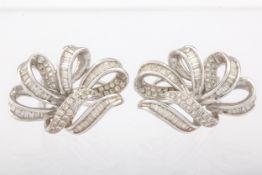 A pair of mid-20th century white gold and diamond open scrolling ear clips.