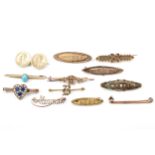A collection of eleven gold and yellow metal brooches, Some gem set.