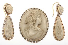 A Victorian gilt-metal and lava cameo brooch and a pair of pendant earrings.