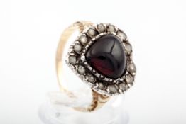 A Victorian garnet and rose diamond heart-shaped cluster adapted as a ring.