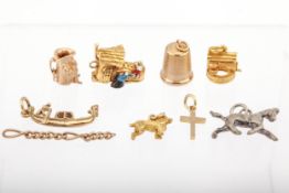 Seven vintage 9ct gold charms and other items.