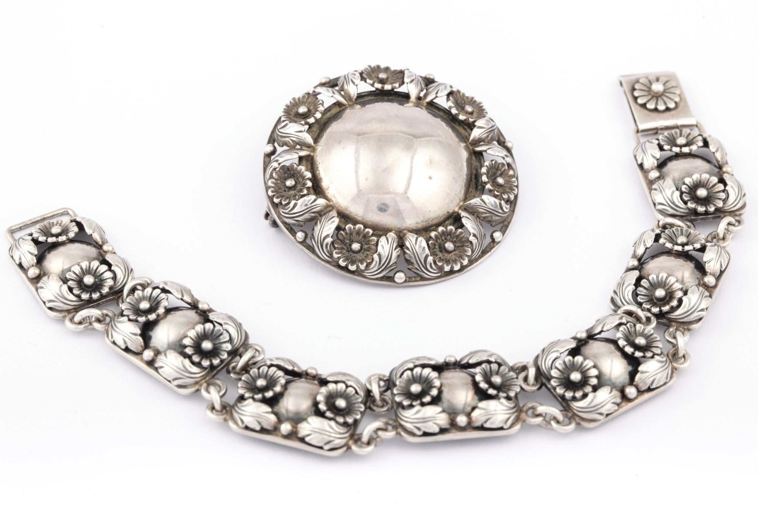 A Danish sterling floral panel bracelet and a round brooch by N E From.