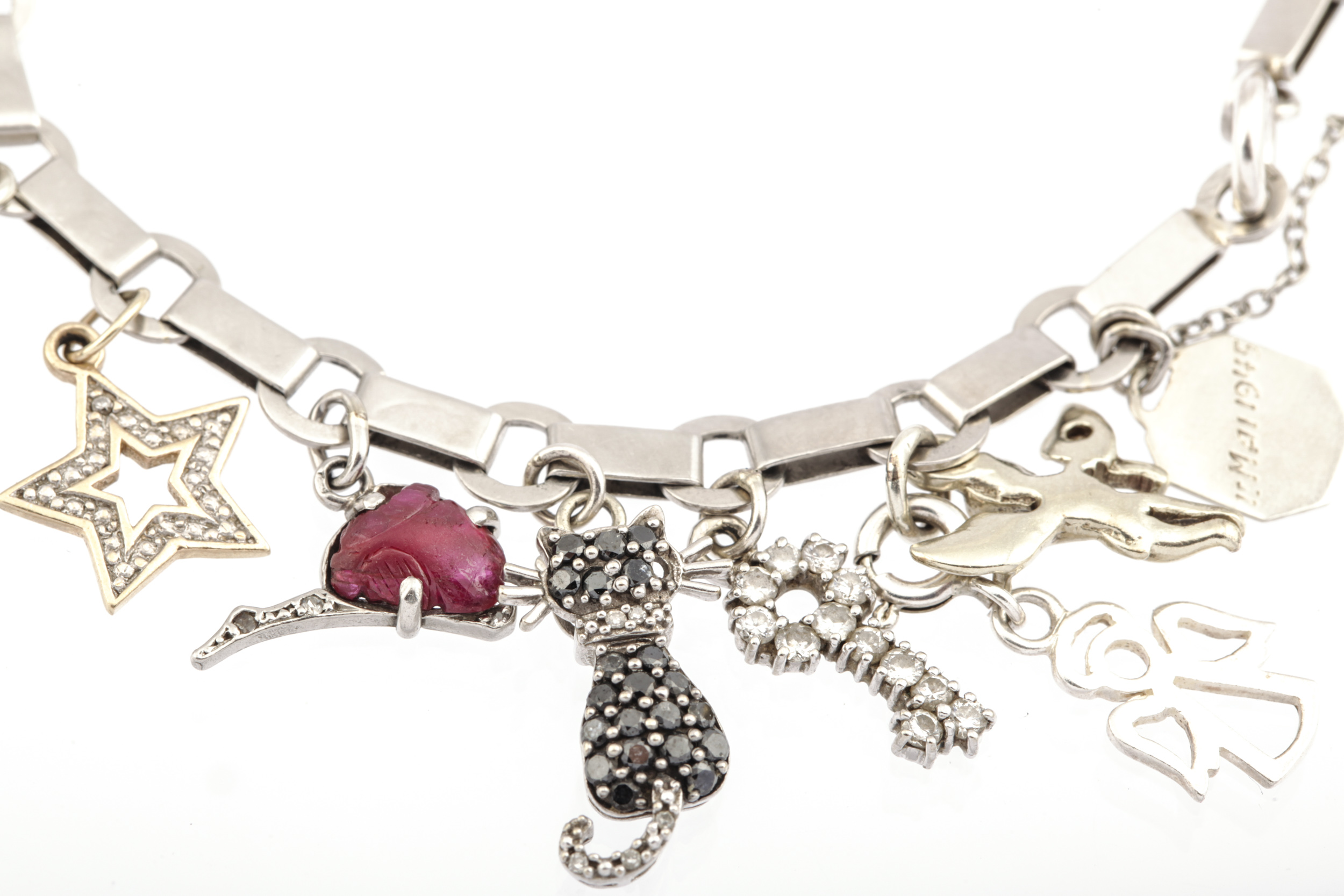 A 1940s French platinum bracelet in the manner of Boucheron hung with 21 various charms. - Image 2 of 6