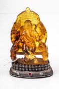 An Indian carved amber-type statue of Ganesha.