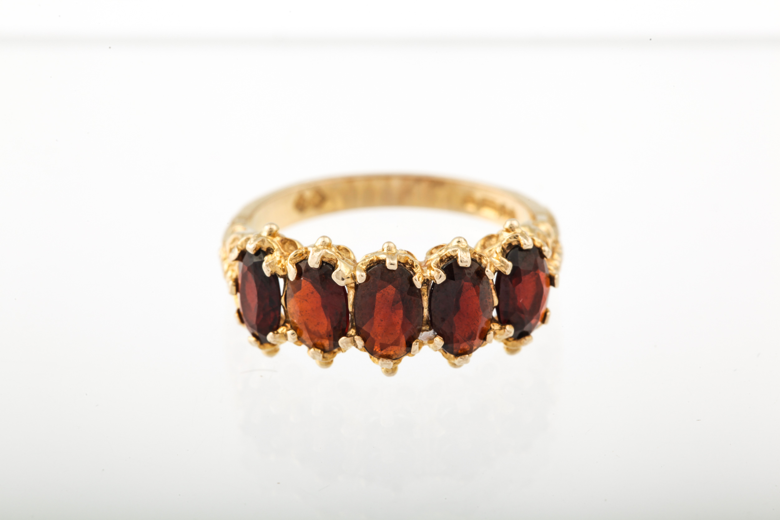 A vintage 9ct gold and garnet five stone ring. - Image 6 of 6