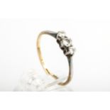 A mid-20th century gold and diamond three stone ring. The graduated round brilliants approx. 0.