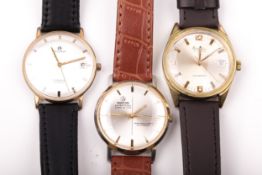 Three vintage gentleman's gold-plated and stainless steel round wristwatches.