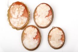 Four vintage gold and oval shell cameo brooches depicting unknown female busts.