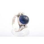 A mid-20th century cabochon sapphire and diamond dress ring.