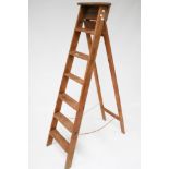 A vintage wooden step ladder. With six rungs.