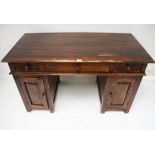 A contemporary hardwood twin pedestal desk. With three drawers over two cupboards.