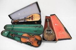 A collection of three vintage string musical instruments.