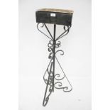 A vintage wrought iron plant stand.