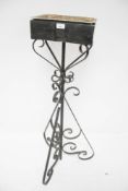 A vintage wrought iron plant stand.