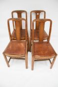 A set of four oak framed dining chairs.