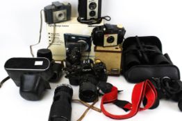 A collection of assorted vintage cameras and binoculars.