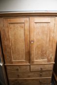 A substantial one piece vintage stripped pine cupboard.