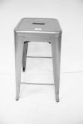 A classic pressed grey metal bar stool.
