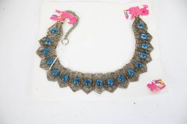 A white metal filigree necklace. Set with turquoise-blue coloured glass cabochons. Approx.