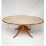 A vintage pine table. Of oval form, raised on a turned column with four swept supports, H74.