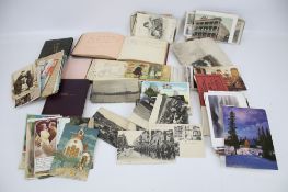 A collection of assorted ephemera, postcards and autograph books.