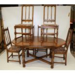 An Ercol oak and elm extending dining table and six chairs.