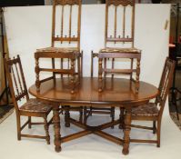 An Ercol oak and elm extending dining table and six chairs.