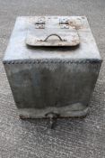 A riveted zinc water tank or planter.